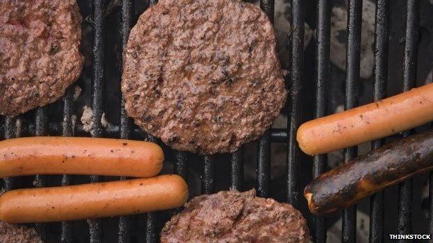 Burgers and sausages on BBQ