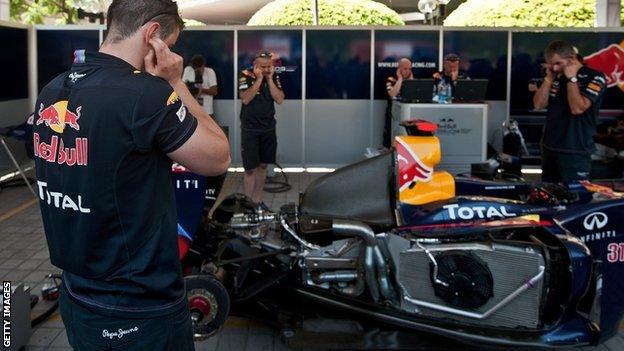 Red Bull engineers work on their car