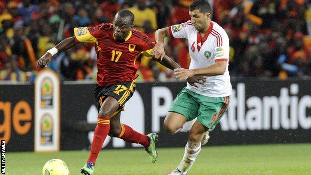 Morocco's midfielder Adil Hermach (R) challenges Angola's forward Mateu