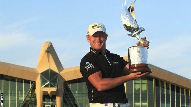 Jamie Donaldson proudly displays the Abu Dhabi Championship trophy