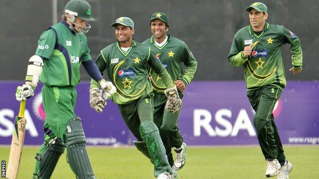 Pakistan players celebrate after taking the wicket of Ed Joyce at Stormont in 2011