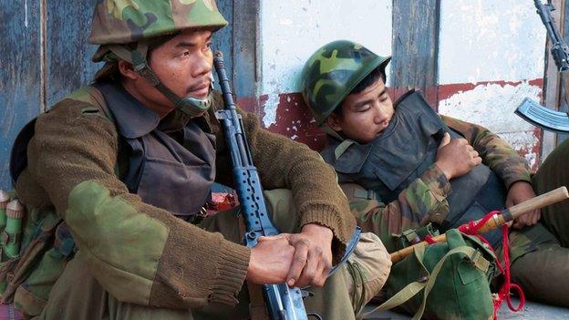 Kachin rebel soldiers return exhausted from the front line