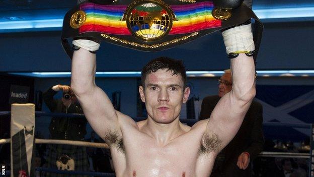 Willie Limond holds aloft the Commonwealth light welterweight belt