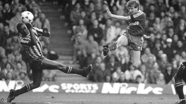 Ronnie Whelan shoots for goal past Brentford defender Roger Stanislaus in the FA Cup quarter-final at Anfield in 1989