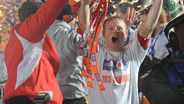 Cliftonville's George McMullan lifts the League Cup