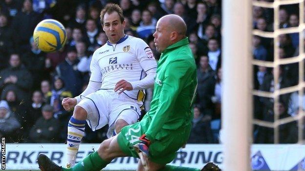 Luke Varney clips the ball past Brad Friedel to put Leeds ahead