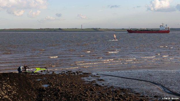 An oil tanker and windsurfers