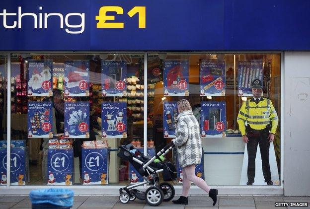 Cut-out of a police officer outside a pound shop