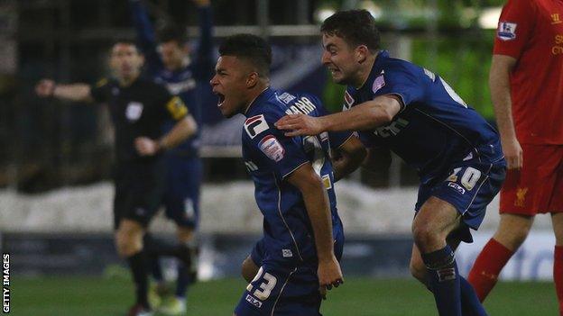 Reece Wabara celebrates his goal for Oldham against Liverpool