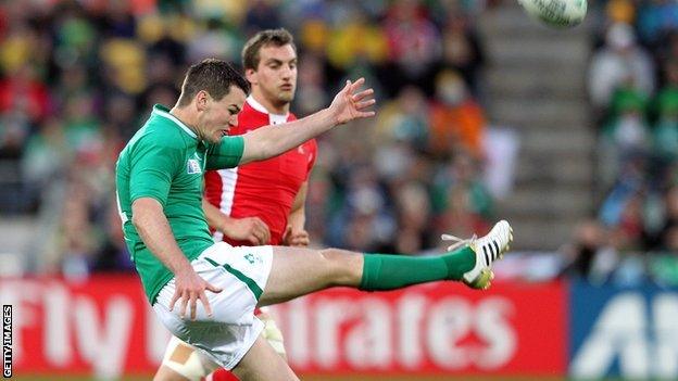 Ireland fly-half Jonathan Sexton kicks under pressure from Wales captain Sam Warburton