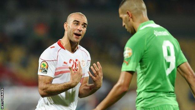 Tunisia's Aymen Abdennour (L) and Algeria's Islam Slimani