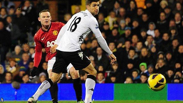 Manchester United striker Wayne Rooney (left) scores his side's winner at Fulham