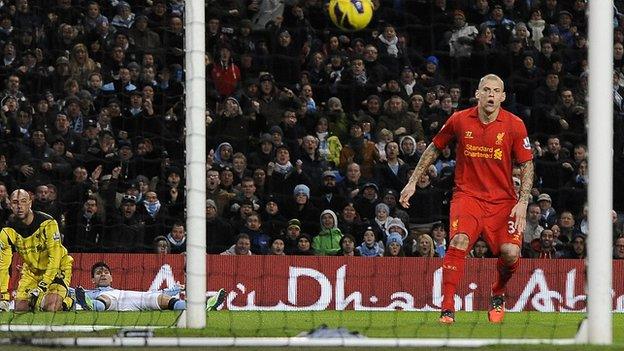 Manchester City striker Sergio Aguero (centre) looks on as he scores his side's equaliser against Liverpool