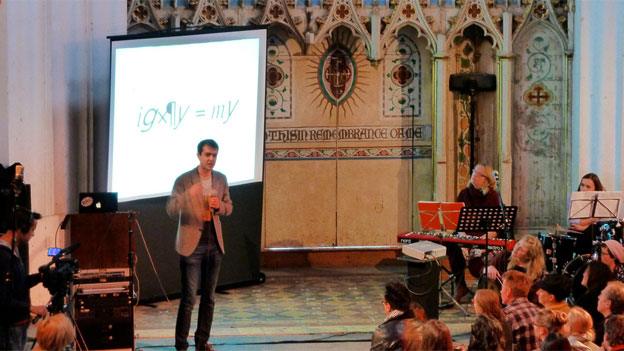 Harry Cliff gives his science lecture at the Sunday Assembly in a former church