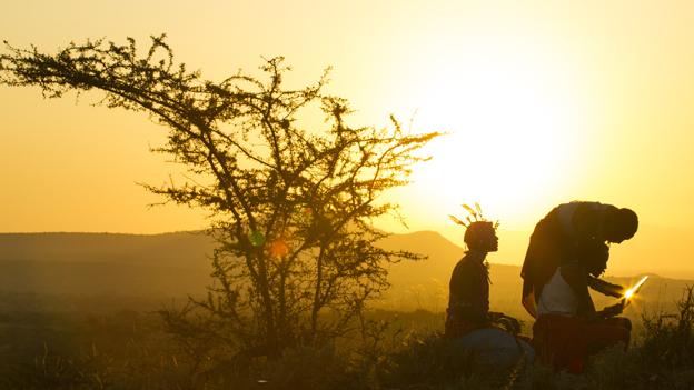 Using a computer at sunset