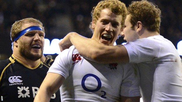 Joe Launchbury (right) congratulates Billy Twelvetrees on his maiden England try as Scotland prop Euan Murray looks on