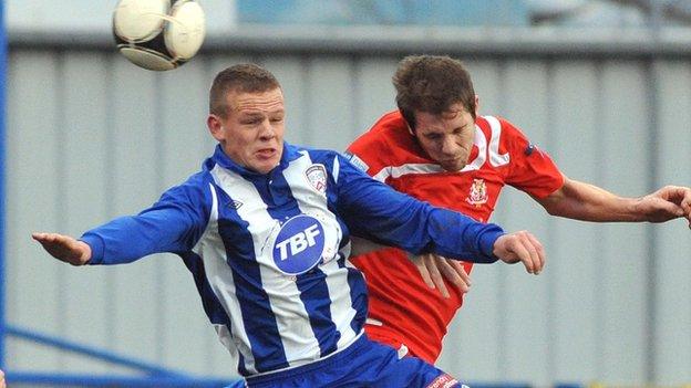 Coleraine's Aaron Canning beats Portadown opponent Richard Lecky to the high ball