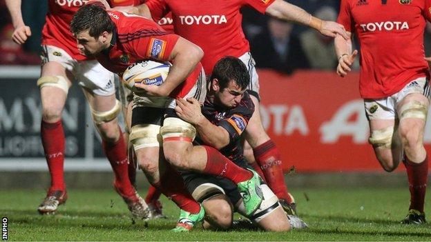 CJ Stander of Munster is tackld by Edinburgh's Stuart McInally