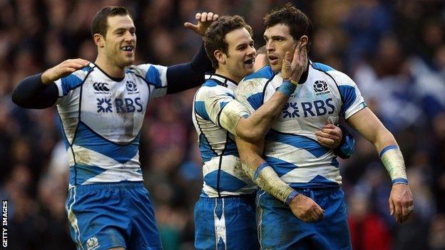 Sean Lamont (R) of Scotland celebrates scoring a try with Tim Visser (L) and Ruaridh Jackson