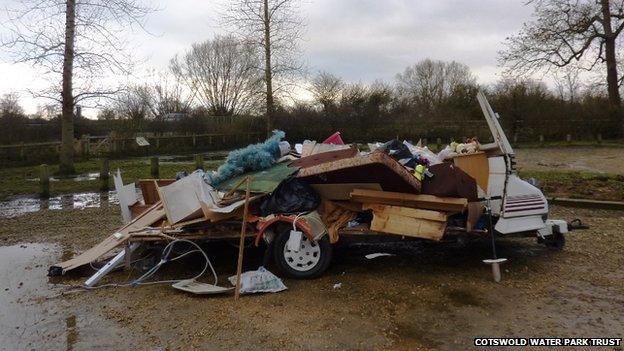 A caravan, filled with household waste, is dumped at Waterhay car park, part of Cotswold Water Park