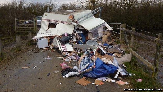 A caravan, filled with household waste, is dumped at Waterhay car park, part of Cotswold Water Park