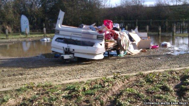 A caravan, filled with household waste, is dumped at Waterhay car park, part of Cotswold Water Park