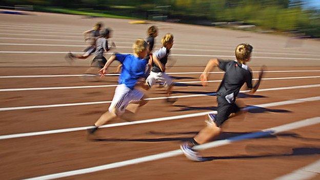 Children running around a track