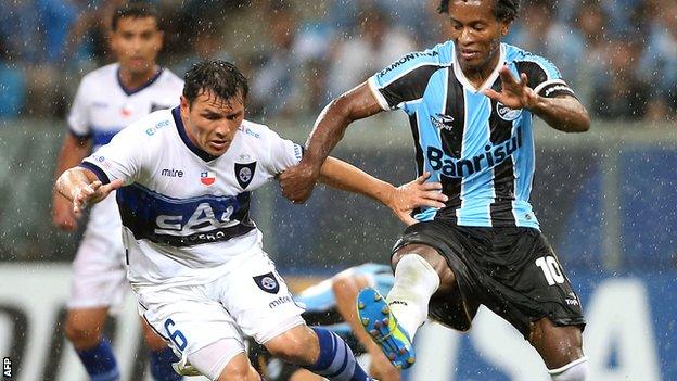 Mauricio Yedro of Huachipato (left) takes on Gremio's Ze Roberto