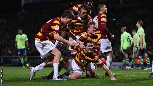 Bradford players celebrate scoring against Aston Villa