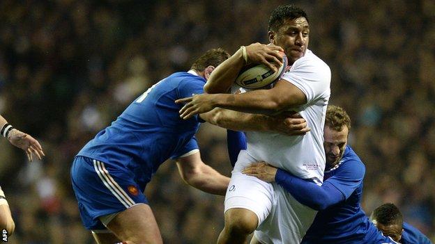 England's Mako Vunipola (centre) is tackled