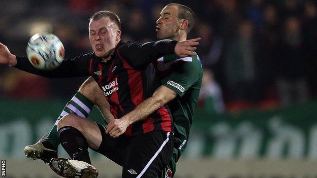 Crusaders striker Jordan Owens competes against Dan Murray of Cork City