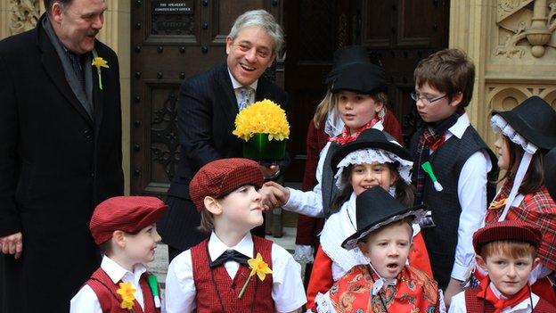 Commons Speaker John Bercow, watched by Plaid Cymru MP Elfyn Llwyd, receives daffodils from Ysgol Gymraeg Llundain pupils