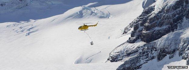 Helicopter dropping bait over South Georgia