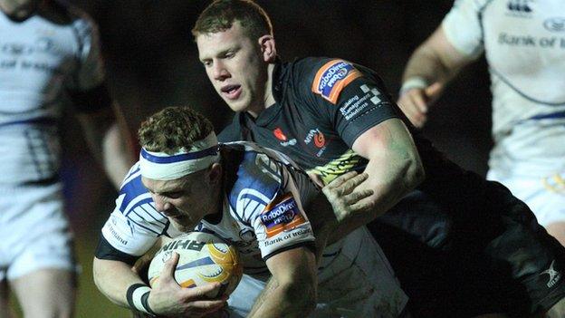 Ian Madigan of Leinster is tackled