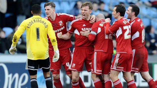 Swindon celebrate Darren Ward's last-minute winner at the Ricoh Arena