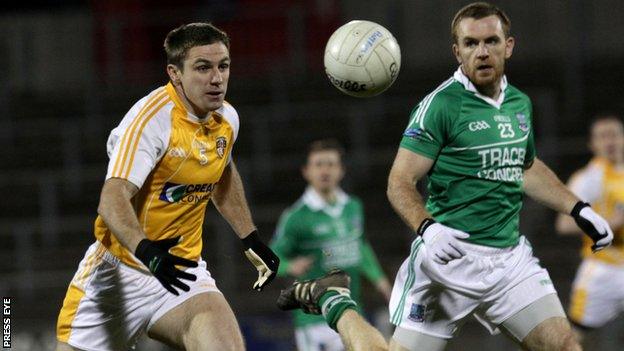 Antrim's Tony Scullion looks set to beat Martin McGrath to possession