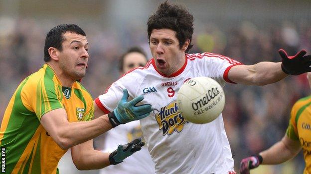 Tyrone's Sean Cavanagh attempts to block a Frank McGlynn handpass at Healy Park