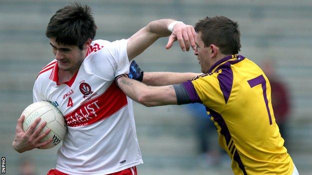 Derry's Chrissy McKaigue tries to hold off Wexford's Adrian Flynn