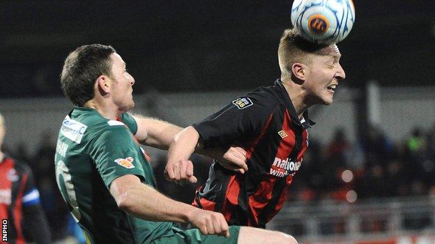 Cork's Denis Behan challenges Chris Morrow in the second leg