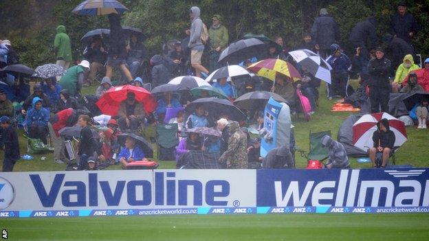 Spectators wait in vain for the rain to stop in Dunedin