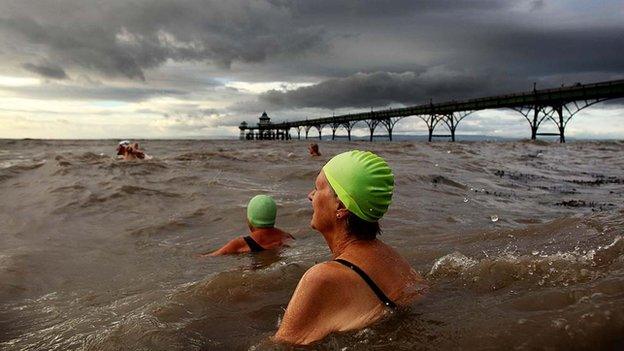 Swimmers in the water next to Clevedon Pier.