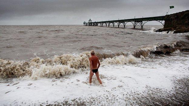 A sea swimmer enters the water next to Clevedon Pier.