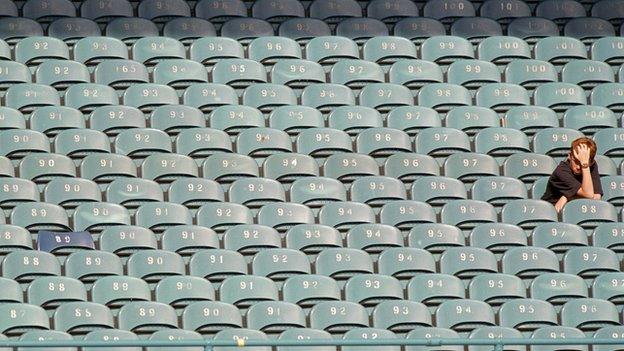 Football fan sitting alone in the stands