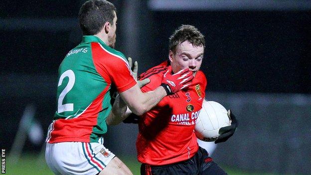 Mayo Chris Barrett challenges Brendan McArdle