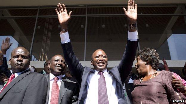 Uhuru Kenyatta (C) greets supporters beside his running mate William Ruto (2nd L) as they celebrate winning the presidential election after the official result was released in Nairobi. Kenya on 9 March 2013