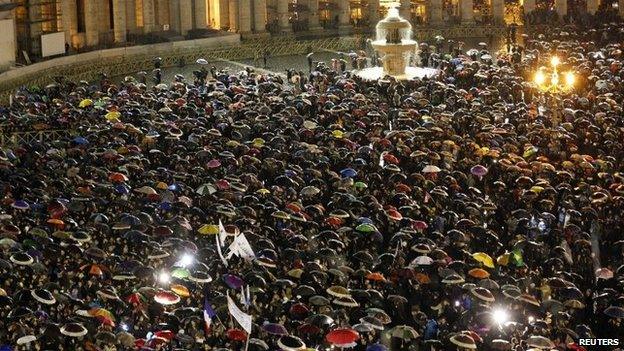 Crowds gather as they wait for the newly elected pope to appear on the balcony of St Peter's Basilica at the Vatican after being elected by the conclave of cardinals on Wednesday evening