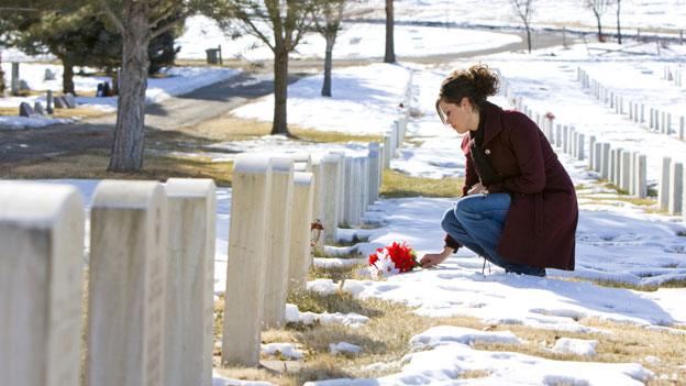 Mourner laying flowers