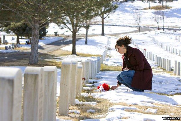 Mourner laying flowers