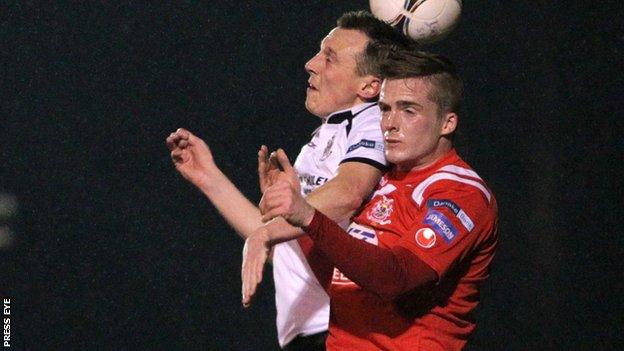 Michael Halliday of Lisburn Distillery in action against Portadown's Aaron Burns