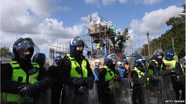 Police officers and bailiffs surround the main barricade during the eviction of Dale Farm travellers camp on October 19, 2011